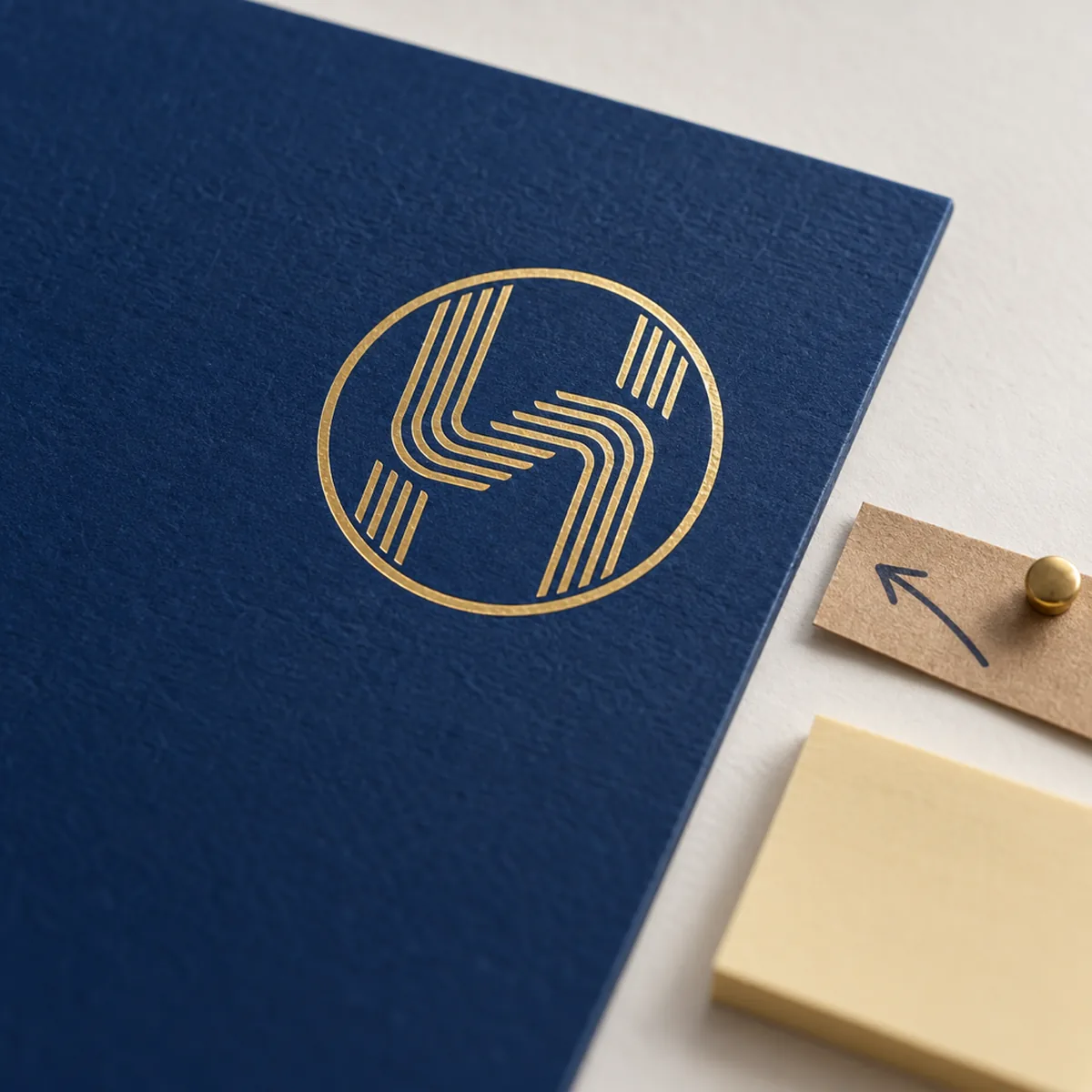 The gold Trus Holding emblem on a navy board with a blank sticky note and a kraft arrow pinned beside it