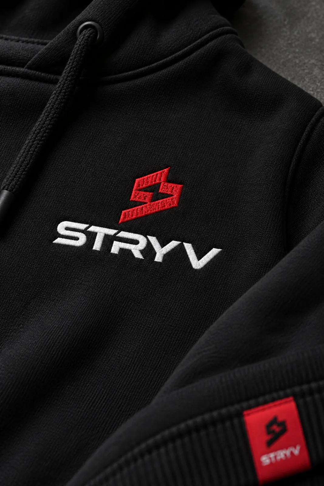 The STRYV logo embroidered on a black hoodie