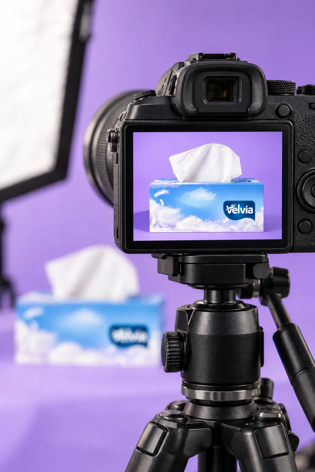 A camera screen showing a Velvia product shot with the set behind