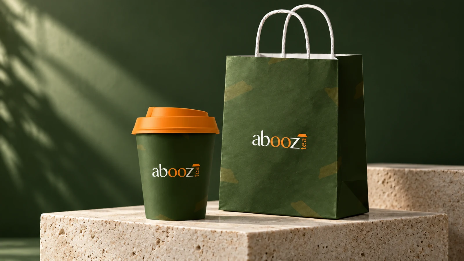Abooz: dark-green takeaway cup and matching branded paper bag, presentation cover