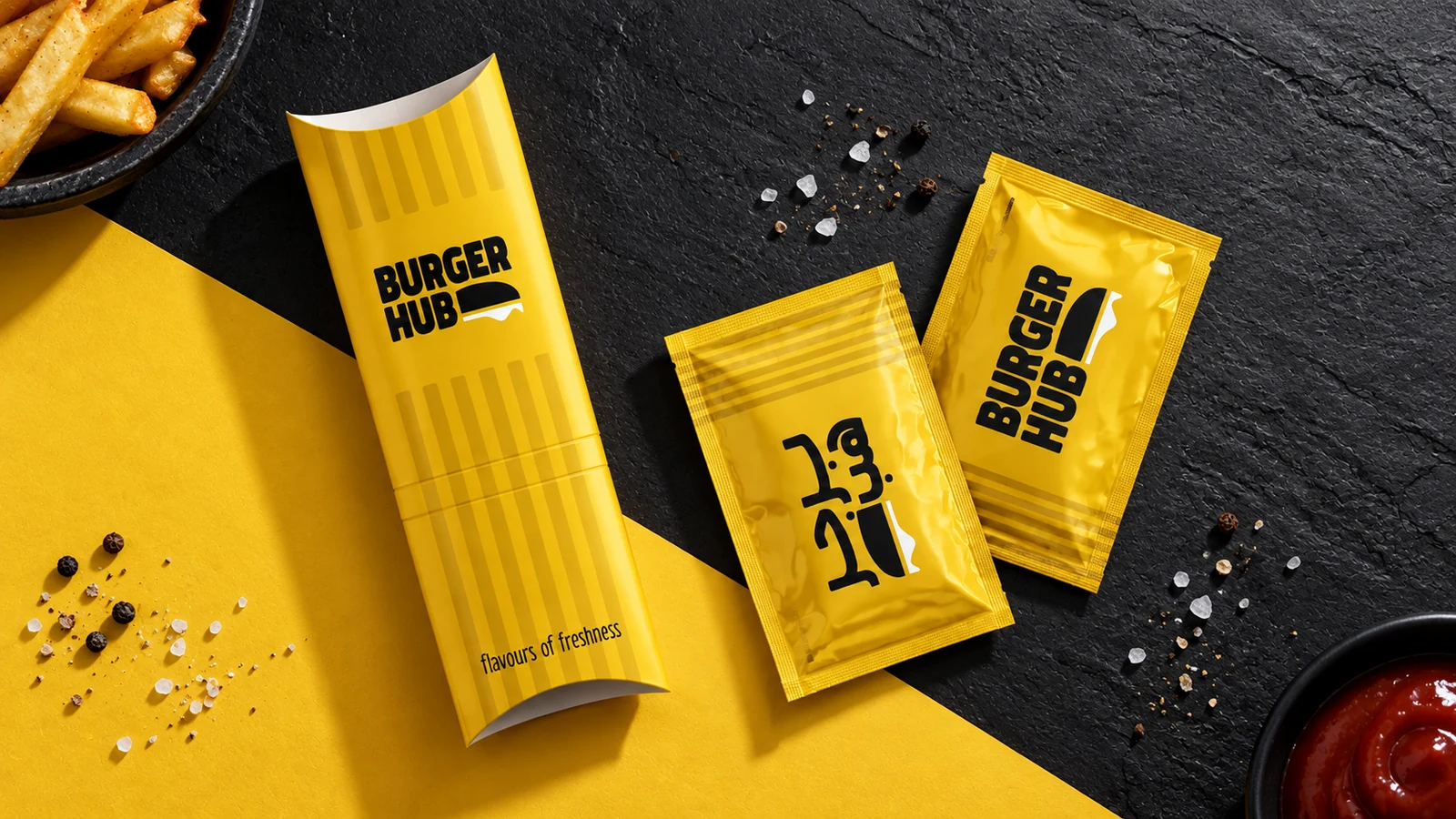 Burger Hub: yellow fries carton and condiment sachets with black Burger Hub branding, presentation cover