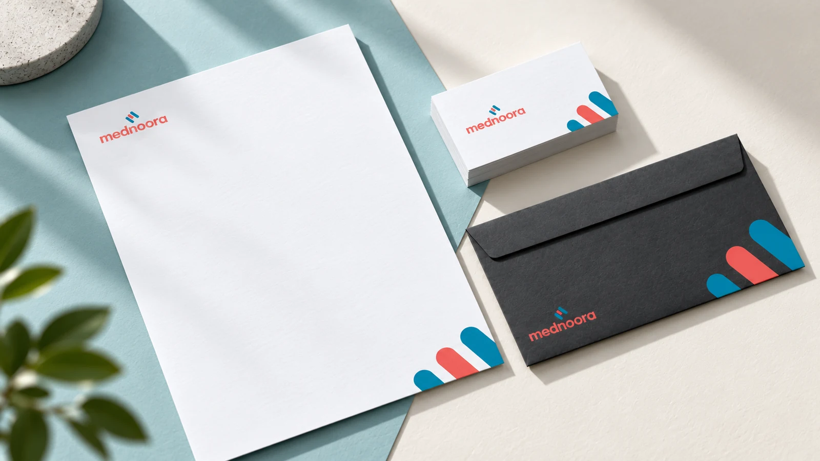 Mednoora: white letterhead and business cards with a coral-and-teal medical symbol, presentation cover