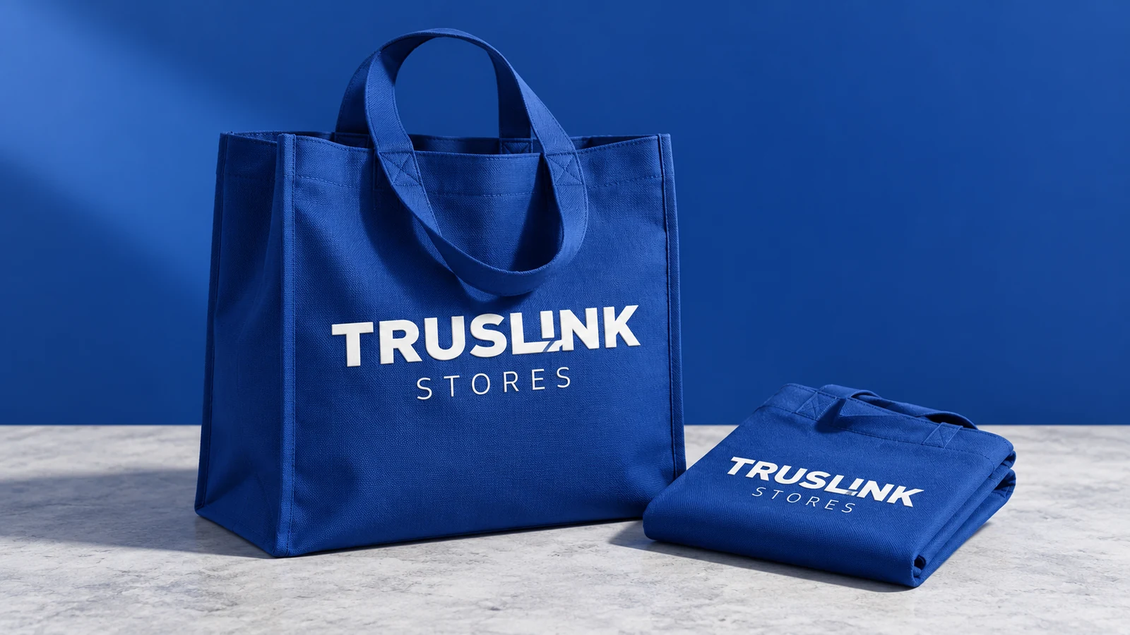 Truslink: blue branded shopping bag and folded staff shirt, presentation cover
