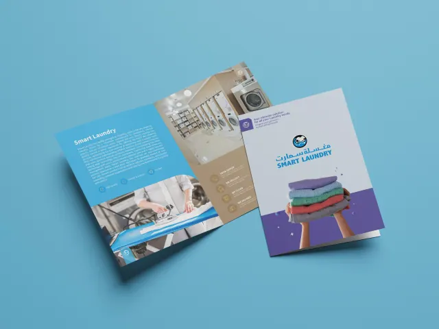 Print: a laundry brochure with washing machines and folded towels in blue, cream and purple.