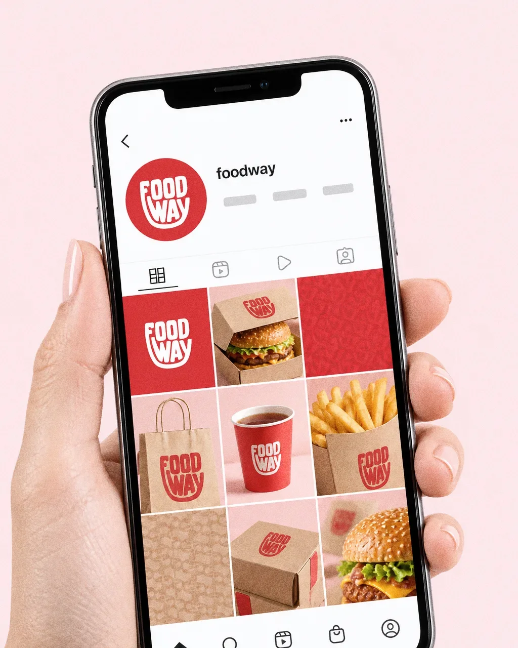 A hand holding a phone against pale pink, showing a Food Way Instagram grid of red logo tiles, kraft packaging, burgers, fries and a red cup.