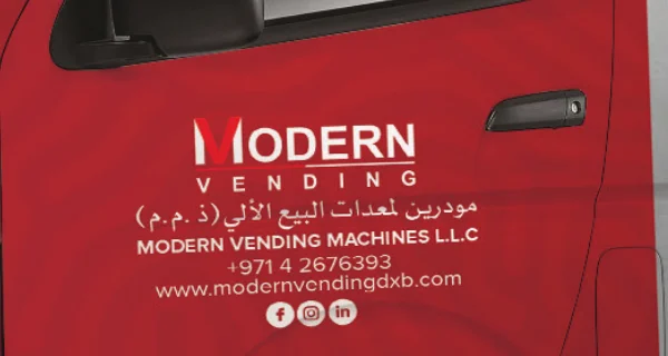 Modern Vending: the wordmark on the driver door above the company name, phone and website in English and Arabic.